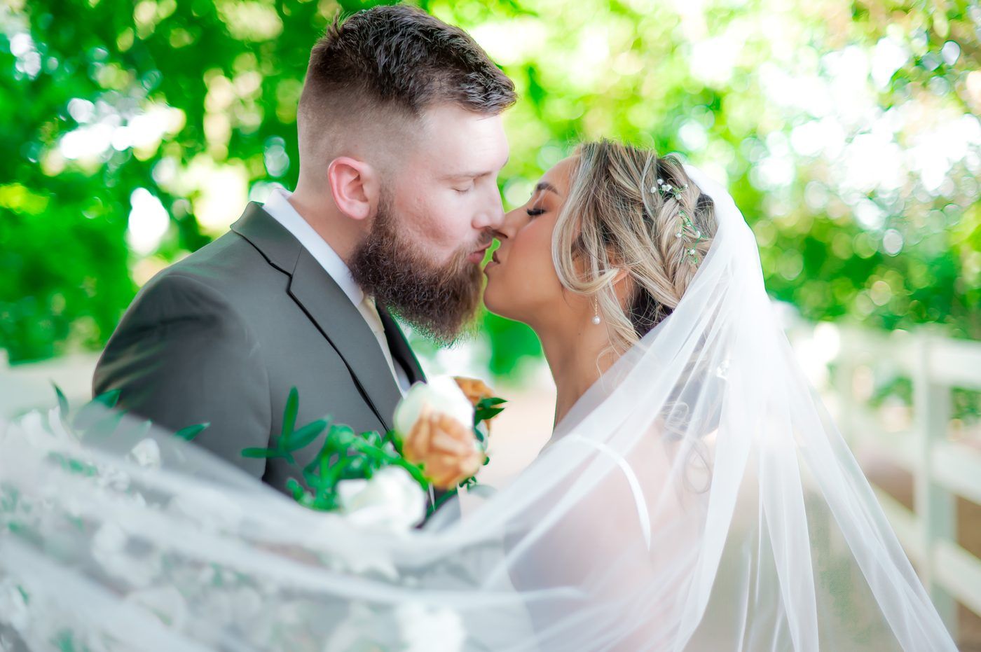 Bride and groom kiss beneath a flowing veil, Las Vegas wedding